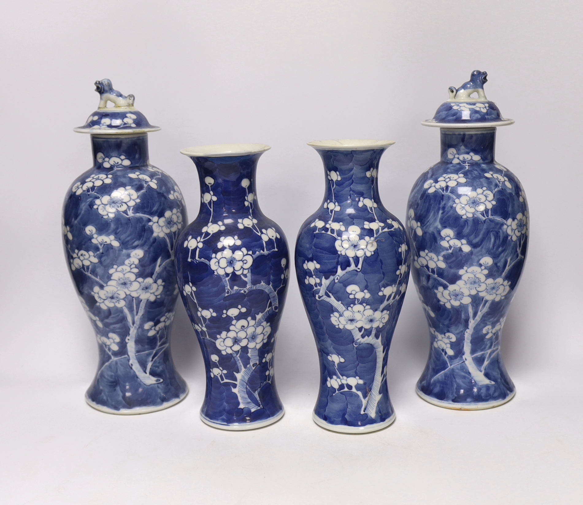 Two pairs of late 19th/early 20th century Chinese blue and white prunus vases, one pair with covers, tallest 30cm